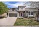 Charming two-story home with a well-maintained front yard, stone accents, and an attached two-car garage at 2749 Pemberly Ave, Highlands Ranch, CO 80126