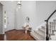 Bright foyer with hardwood floors, a staircase, a bench and ample natural light from the door and sidelight windows at 2749 Pemberly Ave, Highlands Ranch, CO 80126