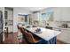 Open kitchen boasts a large island with seating, stainless appliances, and ample counter space, bathed in natural light at 2749 Pemberly Ave, Highlands Ranch, CO 80126