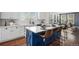 Stylish kitchen featuring a large island with seating, white cabinets, subway tile backsplash, and an open concept layout at 2749 Pemberly Ave, Highlands Ranch, CO 80126
