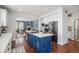 Open kitchen with island and seating flows into the living room with fireplace for effortless entertaining and Gathering gatherings at 2749 Pemberly Ave, Highlands Ranch, CO 80126