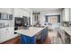 Spacious kitchen featuring a large island, stainless steel appliances, and white cabinetry with ample storage at 2749 Pemberly Ave, Highlands Ranch, CO 80126