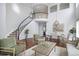 Spacious living room with hardwood floors, spiral staircase, high ceilings, and lots of natural light at 2749 Pemberly Ave, Highlands Ranch, CO 80126