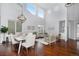 Bright open-concept living room with hardwood floors, dining area, large windows, and stylish decor at 2749 Pemberly Ave, Highlands Ranch, CO 80126