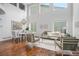 Bright open-concept living room with hardwood floors, dining area, large windows, and stylish decor at 2749 Pemberly Ave, Highlands Ranch, CO 80126