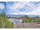 Picturesque neighborhood view with rooftops, lush trees, and distant mountain range under a beautiful blue sky at 2749 Pemberly Ave, Highlands Ranch, CO 80126