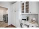 Bright office nook featuring white shaker cabinets, stylish desk, and convenient laundry room access at 2749 Pemberly Ave, Highlands Ranch, CO 80126