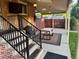 Relaxing covered back porch featuring a table, grill, brick, and view to the yard at 2989 S Corona St, Englewood, CO 80113