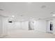 Open basement area with carpet, white walls, recessed lighting, and access to other areas at 2989 S Corona St, Englewood, CO 80113