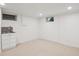 Basement area featuring a modern sink and cabinet combination, recessed lighting, and neutral carpeting at 2989 S Corona St, Englewood, CO 80113