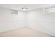 Clean basement with neutral carpet, natural lighting, and neutral walls and trim at 2989 S Corona St, Englewood, CO 80113