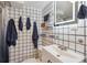 Unique bathroom features black and white tiling, modern fixtures, and ample towel storage at 2989 S Corona St, Englewood, CO 80113