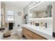 A bright bathroom with double vanity, modern lighting, and updated fixtures at 2989 S Corona St, Englewood, CO 80113