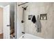Elegant bathroom features sleek tile, dark hardware, and built-in shelving for a modern look at 2989 S Corona St, Englewood, CO 80113