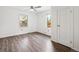 Bedroom features hardwood floors, ceiling fan, and natural light from two bright windows at 2989 S Corona St, Englewood, CO 80113