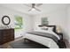 Cozy bedroom with neutral decor, ceiling fan, hardwood floors, and natural light at 2989 S Corona St, Englewood, CO 80113