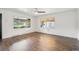 Bright, empty living room featuring hardwood floors and large windows providing ample natural light at 2989 S Corona St, Englewood, CO 80113