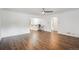 Empty living room featuring hardwood floors and an open view to the kitchen area at 2989 S Corona St, Englewood, CO 80113