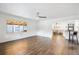 Hardwood floors and an open view to the kitchen area with hardwood floors and natural light at 2989 S Corona St, Englewood, CO 80113