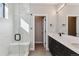 Contemporary bathroom featuring a glass-enclosed shower, double sink vanity, and modern fixtures at 3017 W 53Rd Ave, Denver, CO 80221