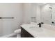 Well-lit bathroom featuring a sleek vanity, toilet, and a modern shower with marble-style tile at 3017 W 53Rd Ave, Denver, CO 80221