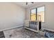 Bright Bedroom with a modern crib, large window, and a cute Winnie the Pooh toy bin at 3017 W 53Rd Ave, Denver, CO 80221