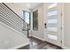 Contemporary entryway with a sleek staircase, abundant natural light, and a modern front door at 3017 W 53Rd Ave, Denver, CO 80221