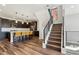 View of kitchen and staircase featuring wood flooring and contemporary black metal railings at 3017 W 53Rd Ave, Denver, CO 80221