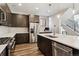 Contemporary kitchen featuring stainless steel appliances, a spacious island, and sleek countertops at 3017 W 53Rd Ave, Denver, CO 80221