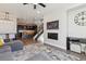 Open-concept living room featuring kitchen, stairway, fireplace, and living area at 3017 W 53Rd Ave, Denver, CO 80221