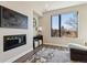 Cozy living room with a modern fireplace, large window, and views at 3017 W 53Rd Ave, Denver, CO 80221