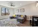 Living room showcasing a sectional sofa, ceiling fan, and a large window with neighborhood views at 3017 W 53Rd Ave, Denver, CO 80221