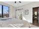 Comfortable main bedroom showing sliding door access to ensuite bath, large window and modern art at 3017 W 53Rd Ave, Denver, CO 80221