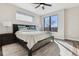 Comfortable main bedroom features a ceiling fan and a large window that allows an abundance of natural light at 3017 W 53Rd Ave, Denver, CO 80221