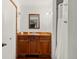 Bathroom with wooden vanity, rustic finishes, and ample lighting, plus a view into the shower at 4923 Snowberry Ln, Evergreen, CO 80439