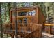 Wood cabin exterior with a balcony and view of the trees at 4923 Snowberry Ln, Evergreen, CO 80439