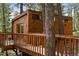 Wooden cabin exterior with a wraparound walkway at 4923 Snowberry Ln, Evergreen, CO 80439