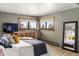 Cozy main bedroom featuring large view windows, built-in storage, and stylish decor at 4923 Snowberry Ln, Evergreen, CO 80439