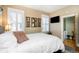 Comfortable bedroom featuring white shutters, a TV, and access to an adjacent room at 2519 N Gilpin St, Denver, CO 80205