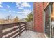 Wood balcony with a red wood paneled home exterior at 343 W Lehow Ave # 22, Englewood, CO 80110