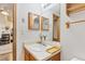 Bathroom featuring modern vanity, lighting, and wall decor at 343 W Lehow Ave # 22, Englewood, CO 80110
