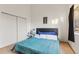 Bedroom featuring closet space, a blue accented bed, and natural light, creating a calming atmosphere at 343 W Lehow Ave # 22, Englewood, CO 80110