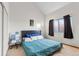 Comfortable bedroom with a high ceiling, closet and a serene blue bed set against neutral walls at 343 W Lehow Ave # 22, Englewood, CO 80110