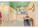 Cozy dining area featuring a unique green ceiling, vintage chandelier, and an open view to the kitchen at 343 W Lehow Ave # 22, Englewood, CO 80110