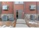 A close-up view of the front door, showing its details and design with heating/cooling units at 343 W Lehow Ave # 22, Englewood, CO 80110