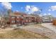 A view of the exterior of this townhouse showcasing its multi-story architecture and surrounding landscaping at 343 W Lehow Ave # 22, Englewood, CO 80110