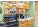 Well-equipped kitchen highlighting a smooth-top range and convenient pass-through to the dining area at 343 W Lehow Ave # 22, Englewood, CO 80110