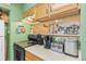Open kitchen view featuring stainless steel appliances and a pass-through to the dining area for easy serving at 343 W Lehow Ave # 22, Englewood, CO 80110