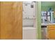 A laundry area featuring a stacked washer and dryer unit, located adjacent to the kitchen space at 343 W Lehow Ave # 22, Englewood, CO 80110
