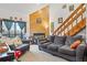 A living room featuring a wooden accent wall with a fireplace, comfortable seating, and access to natural light at 343 W Lehow Ave # 22, Englewood, CO 80110
